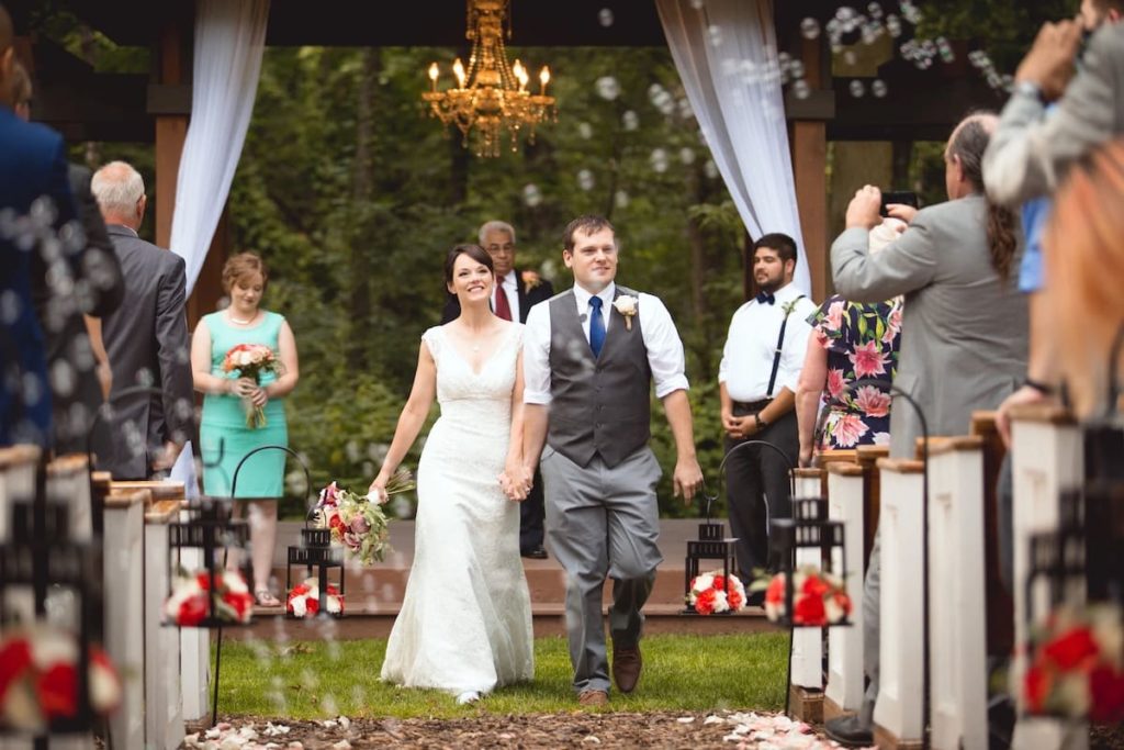 couple walking down the aisle at outdoor wedding